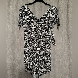Express. Black and ivory flower romper. Tie in the back/open back. Zipper.
